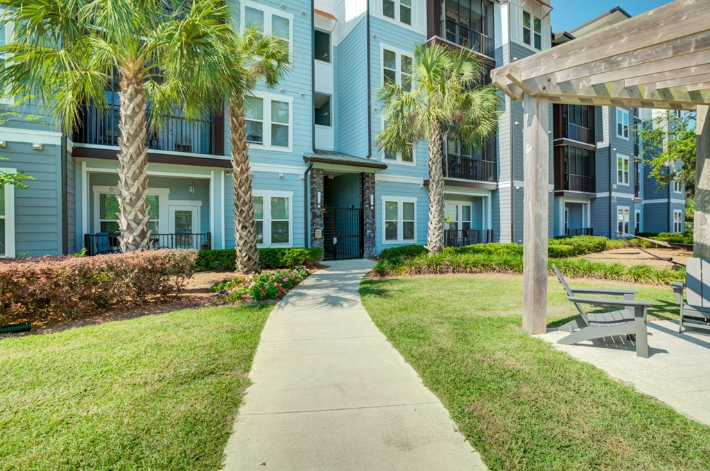 a sidewalk leading to an apartment building with palm trees at Century Town Center, Gainesville, FL, 32607