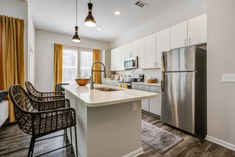 a kitchen with stainless steel appliances and a white counter top