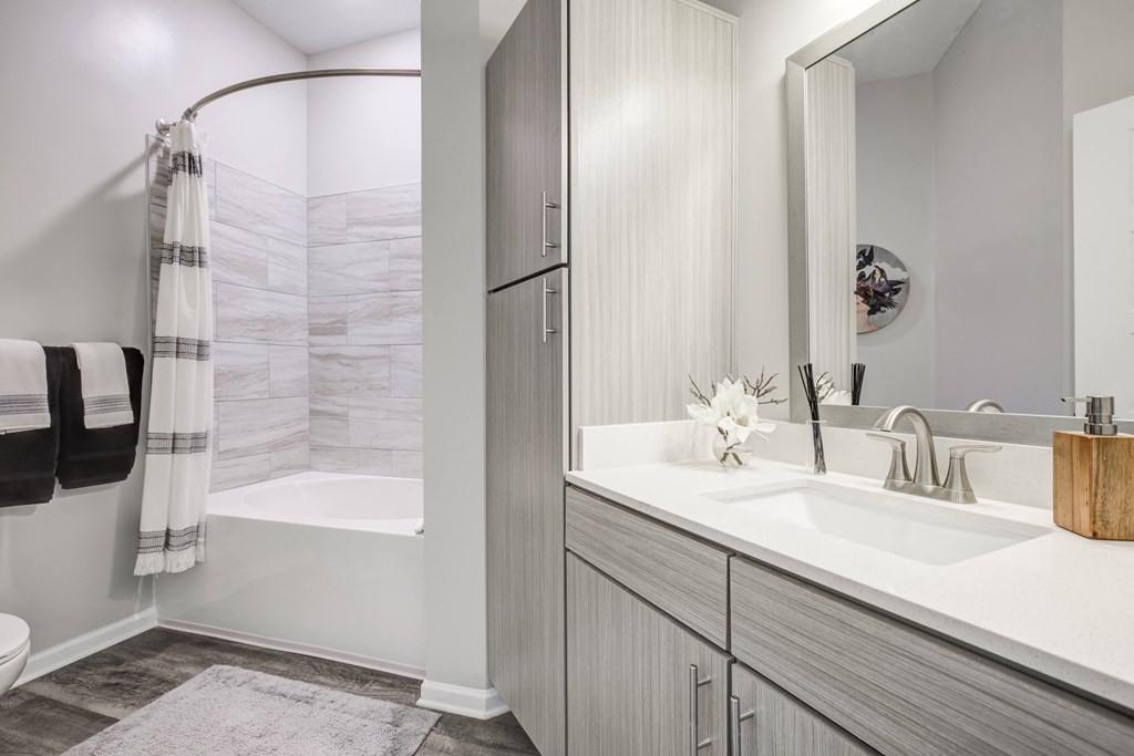 a bathroom with a sink and a mirrorat Century University City, North Carolina, 28213