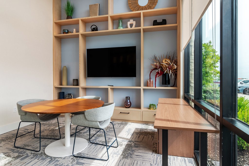 a room with a table and two chairs in front of a large window  at Century West Pryor, Missouri, 64081