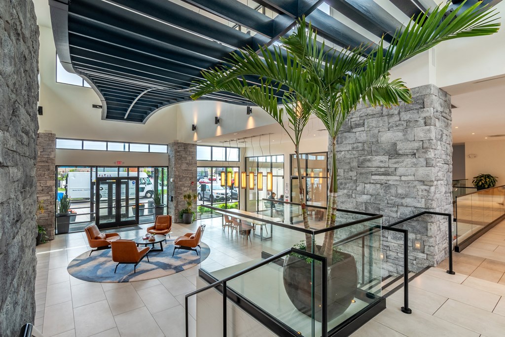 a view of the lobby with a large palm tree in the middle of the floor  at Century West Pryor, Missouri