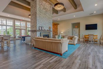 a living room with couches and chairs and a fireplace