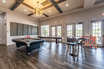 a game room with a pool table and a bar
