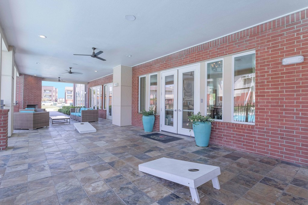 a patio with a white coffee table in front of a brick building at Century Palm Bluff, Portland