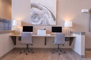 a desk with two computers and two lamps in a room at Century Palm Bluff, Portland