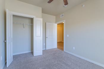 an empty bedroom with a closet and a ceiling fan  at Century Palm Bluff, Portland