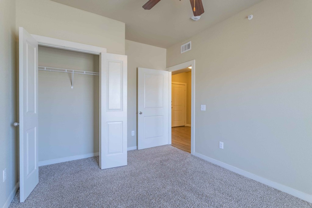 a bedroom with a closet and a ceiling fan at Century Palm Bluff, Portland, TX, 78374