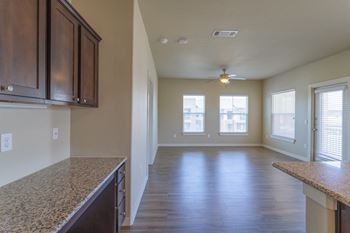 an empty kitchen and living room with a ceiling fan at Century Palm Bluff, Portland, TX, 78374