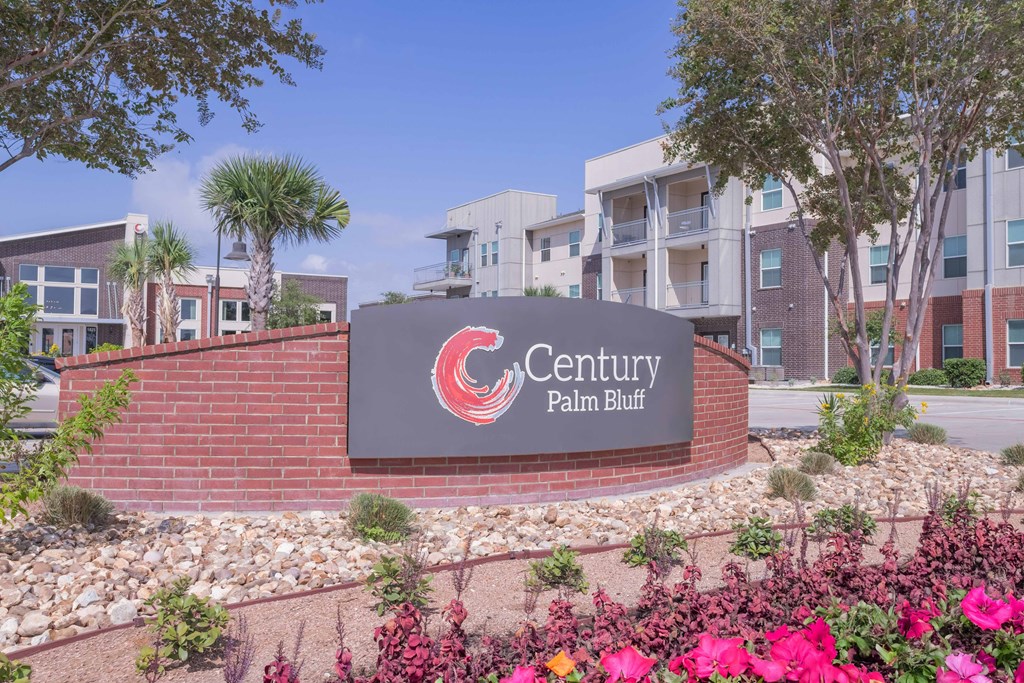 our sign is in front of our building and our apartments are in the background at Century Palm Bluff, Portland, TX, 78374