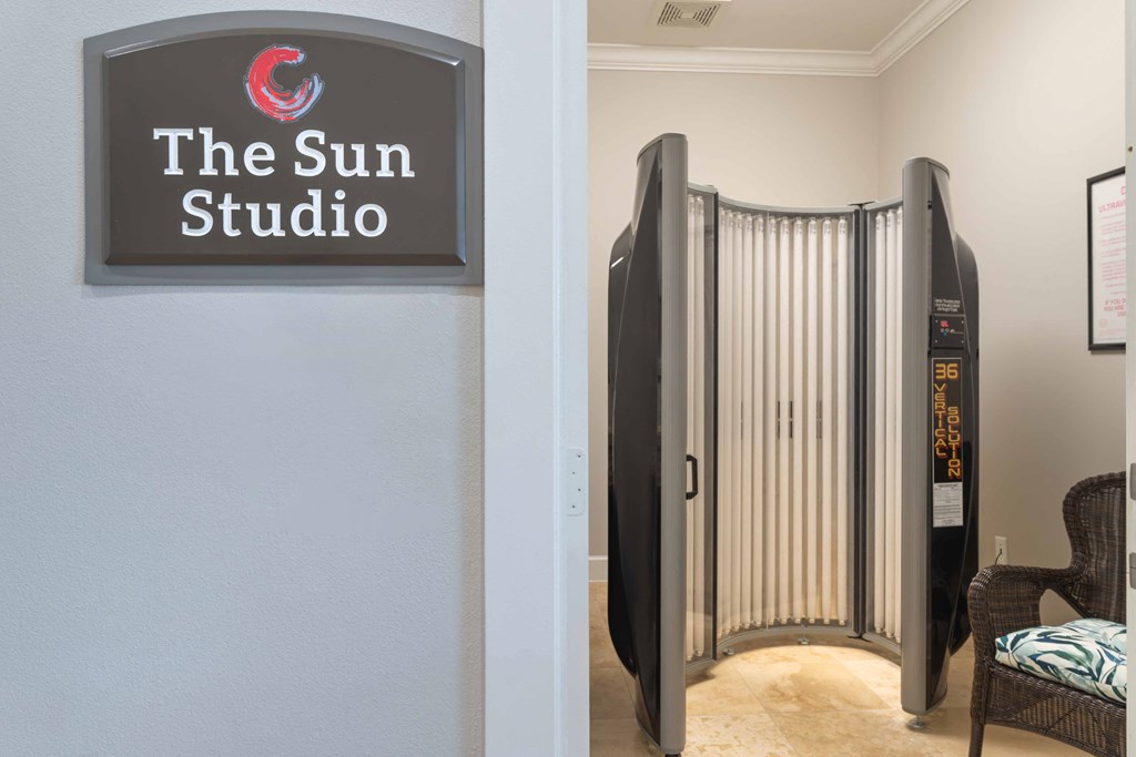 a gate in front of a building with a sign that reads the sun studio at Century South Shore, League City, Texas