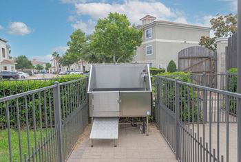 a stainless steel hot tub on a patio with a metal fence at Century South Shore, Texas, 77573