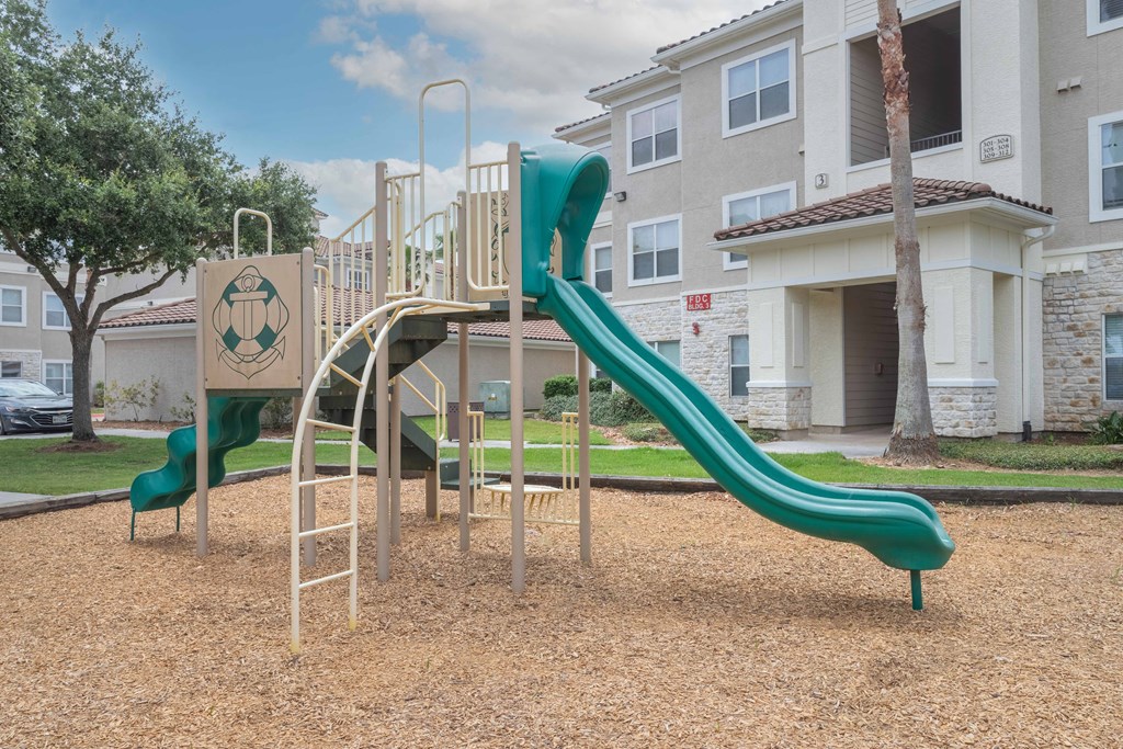 a playground at the whispering winds apartments in pearland, tx at Century South Shore, League City, TX