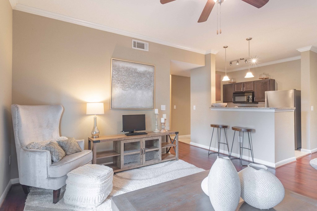 a living room with a couch and a chair at Century South Shore, League City, TX