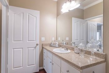 a bathroom with a sink and a mirror at Century South Shore, League City, TX