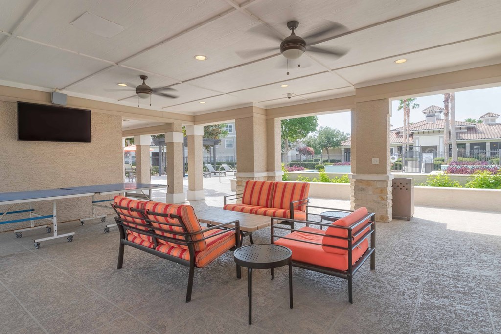 a lobby with couches and chairs and a television at Century South Shore, Texas