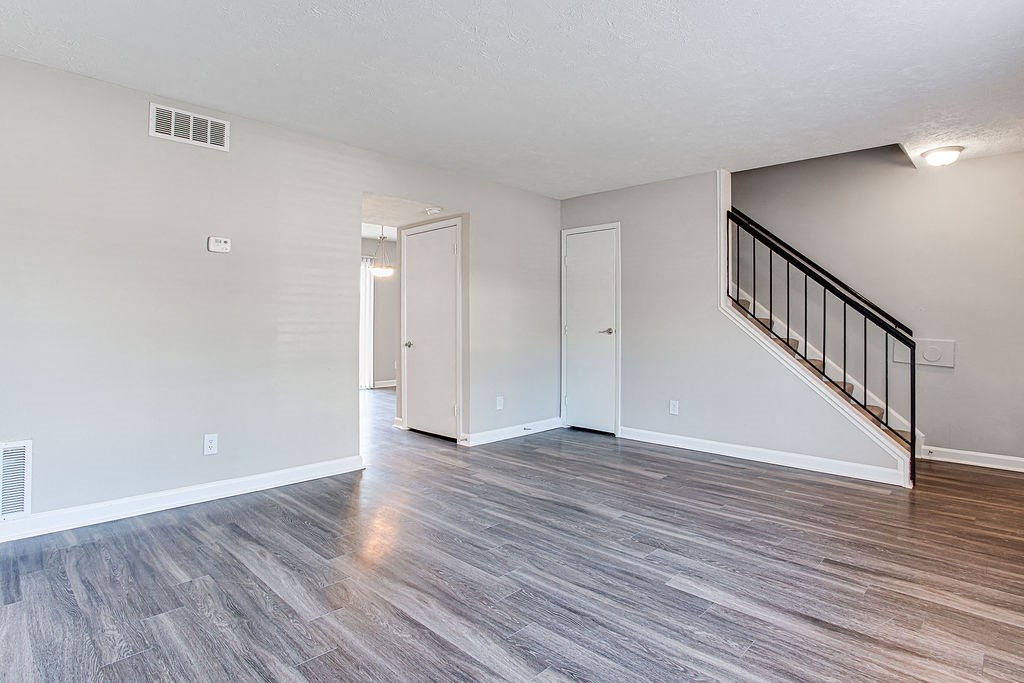 Spacious living room with hardwood like flooring  at Chelsea Place apartments Lithonia, GA