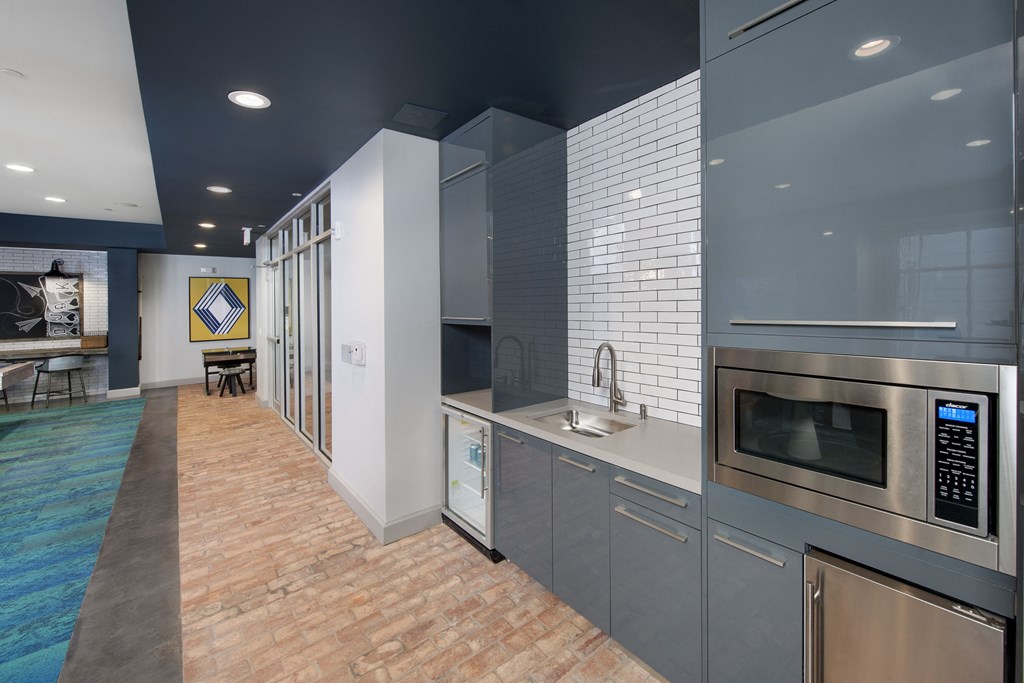 a kitchen with gray cabinets and a brick floor at Marley EAV, Atlanta, GA, 30316
