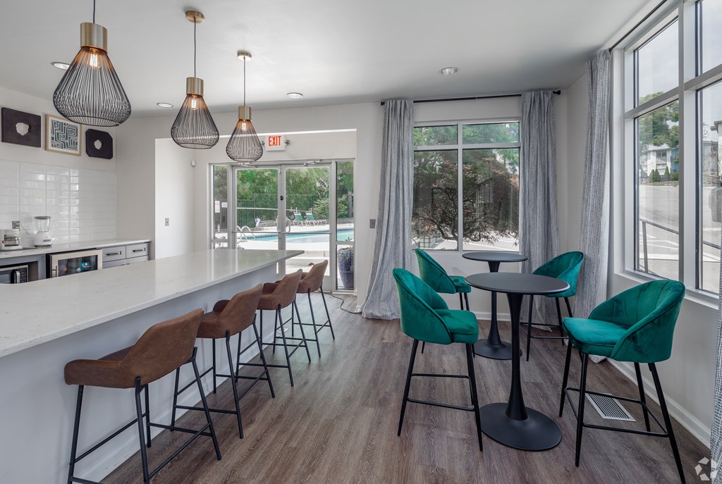 a kitchen with a long counter and a long bar with chairs and stools