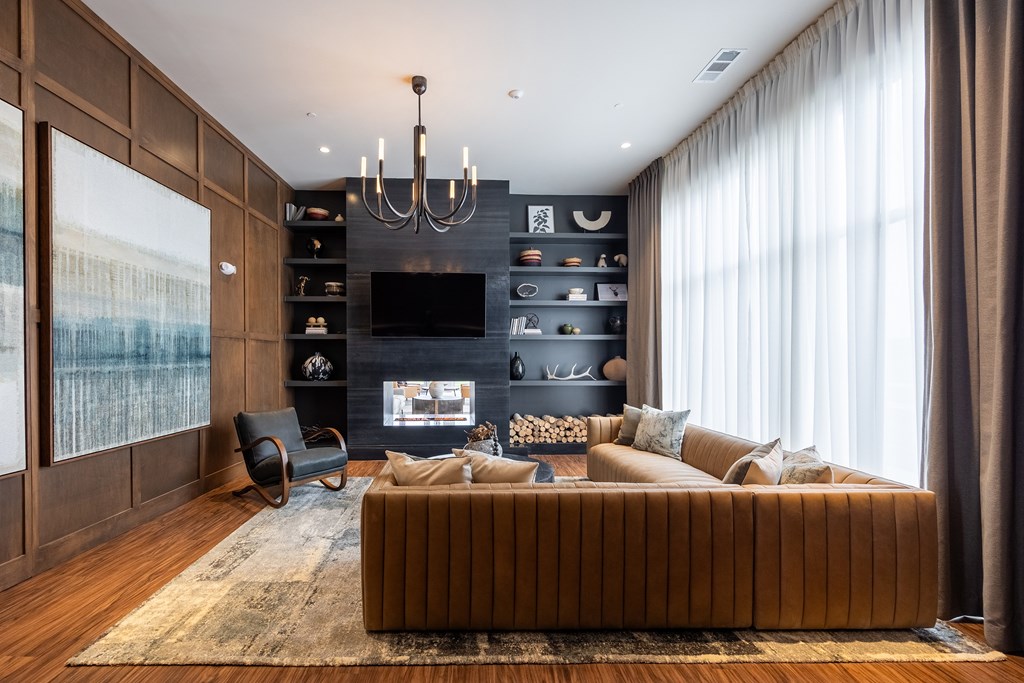 A modern living room with a large sofa and a fireplace.