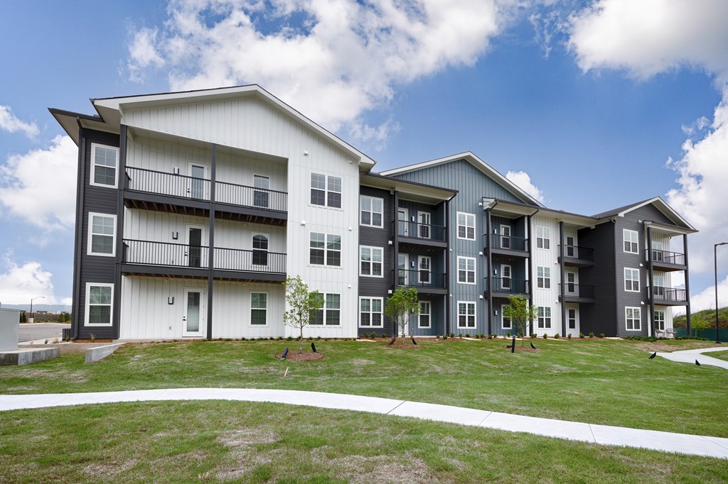 A modern apartment complex with balconies and multiple stories.