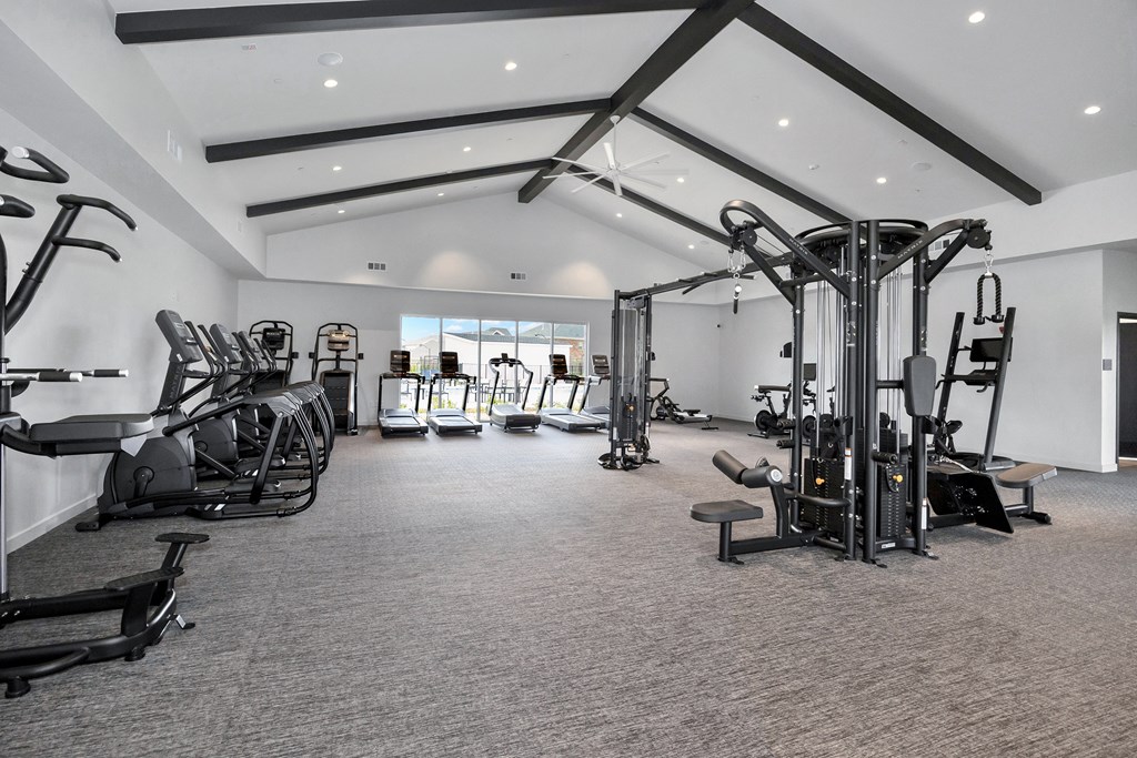 A spacious gym with a variety of equipment.