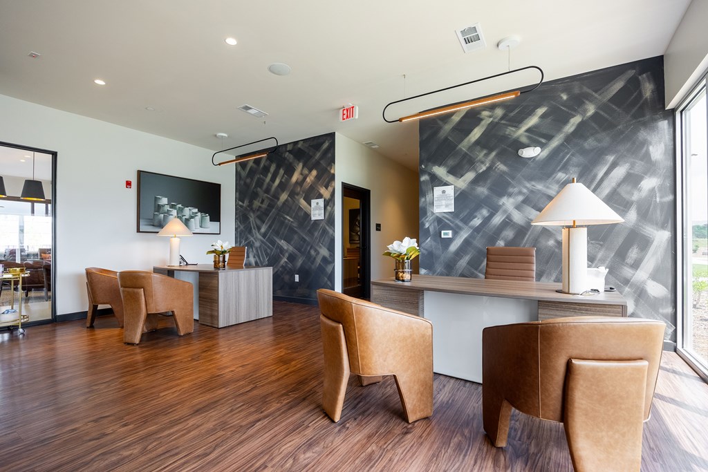 A waiting area with brown chairs and a grey counter.
