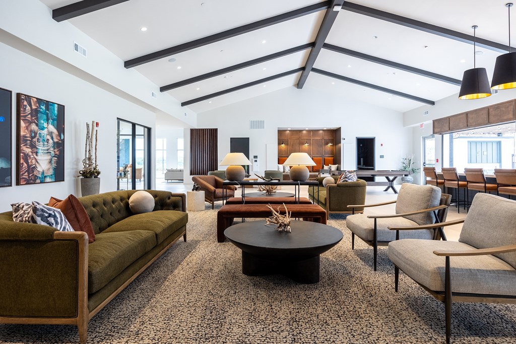 A living room with a green sofa and a coffee table.