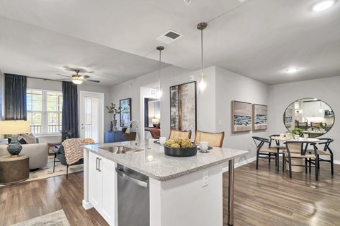 A modern kitchen with a dining table and chairs.