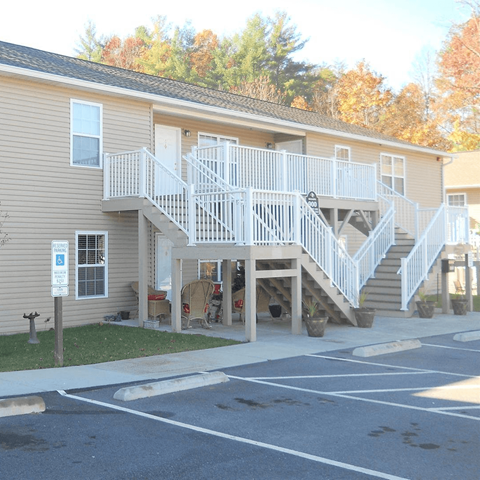a house with a staircase and a parking lot