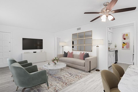 A living room with a grey couch, a green armchair, and a white coffee table.