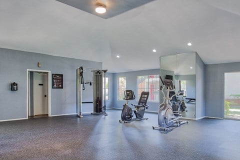 A spacious gym with a variety of exercise equipment.