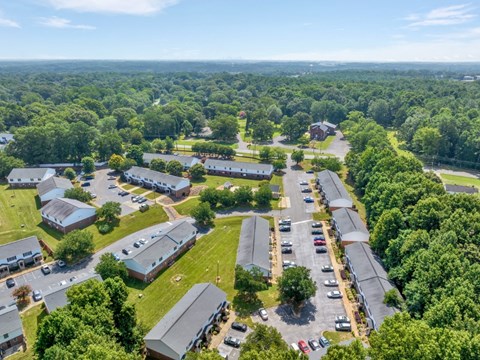 an aerial view of a neighborhood of buildings and a parking lot