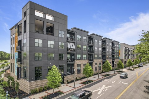 a rendering of an apartment building on a city street
