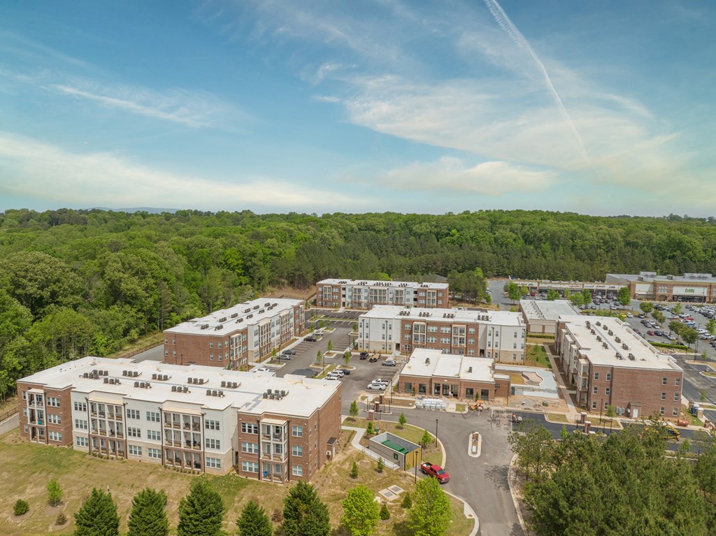 an aerial view of alexandria commons with trees in the background and a blue sky  at The Indigo Apartments, Canton, GA, 30114