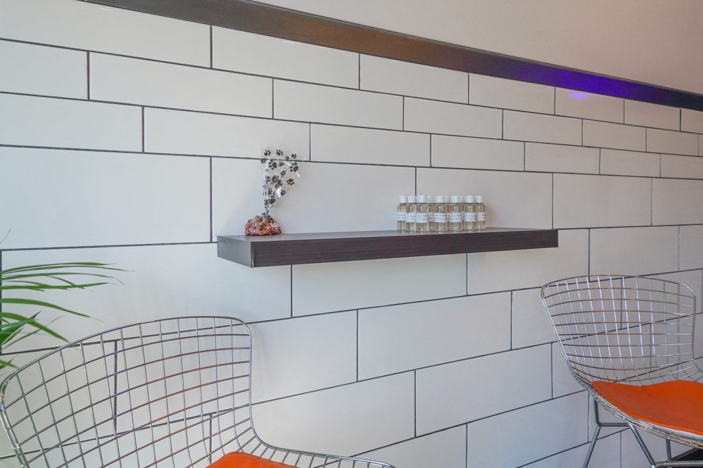 a table and two chairs in front of a wall with a shelf