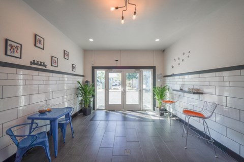 a room with a blue table and chairs and a glass door
