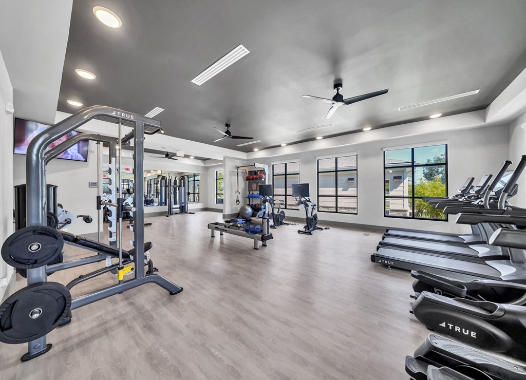a spacious fitness center with treadmills and other exercise equipment