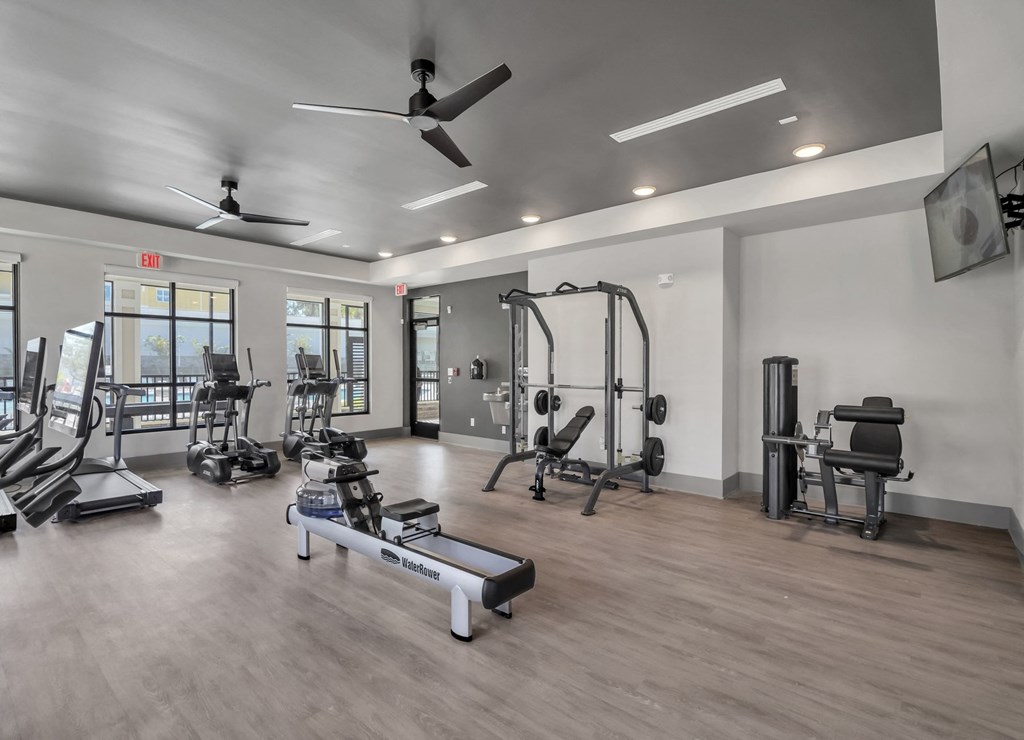 a gym with exercise equipment and ceiling fans at the casey, 2100 delgany,