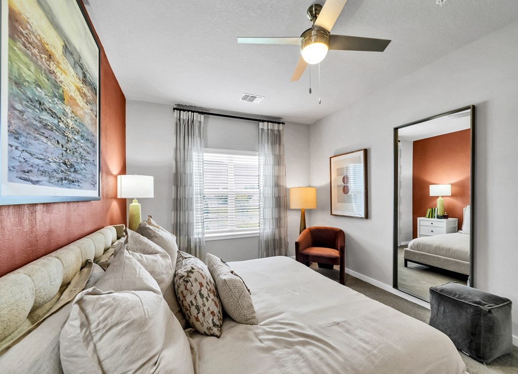 a bedroom with a bed and a ceiling fan