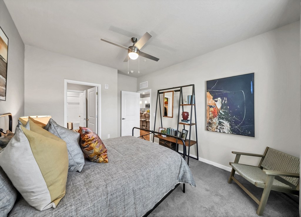 a bedroom with a large bed and a ceiling fan
