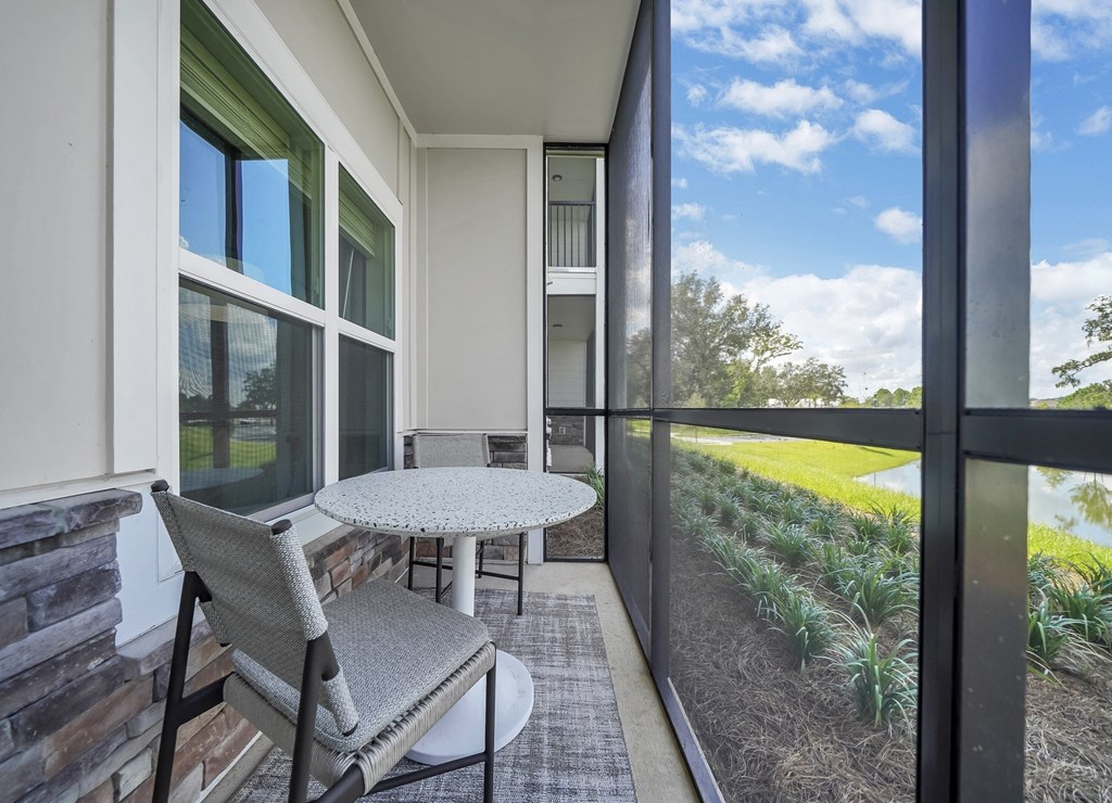 a balcony with a small table and two chairs