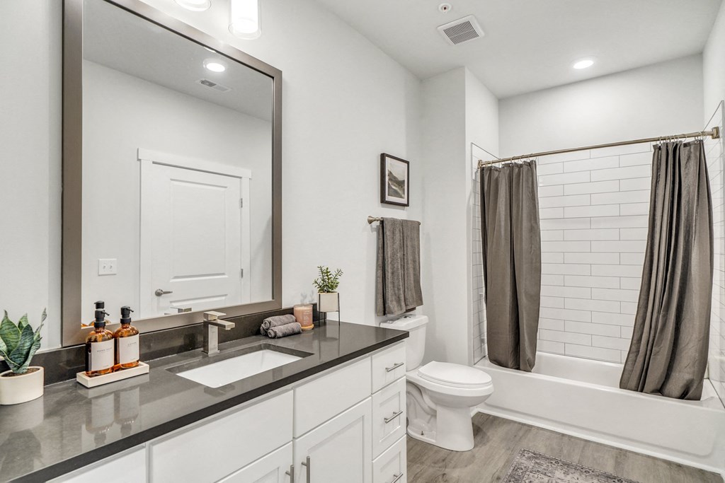 Bathroom with tub and sink at The Charles Apartments, Destin, Florida