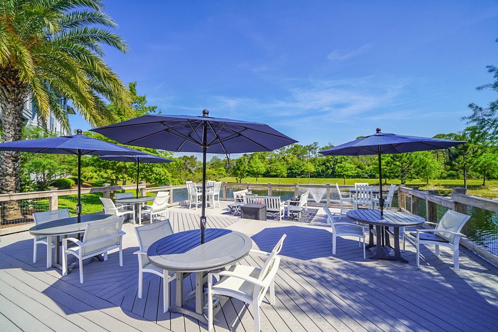 an outdoor patio with tables and chairs and umbrellas