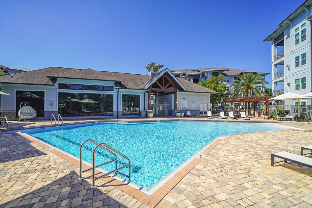 a swimming pool with a building in the background