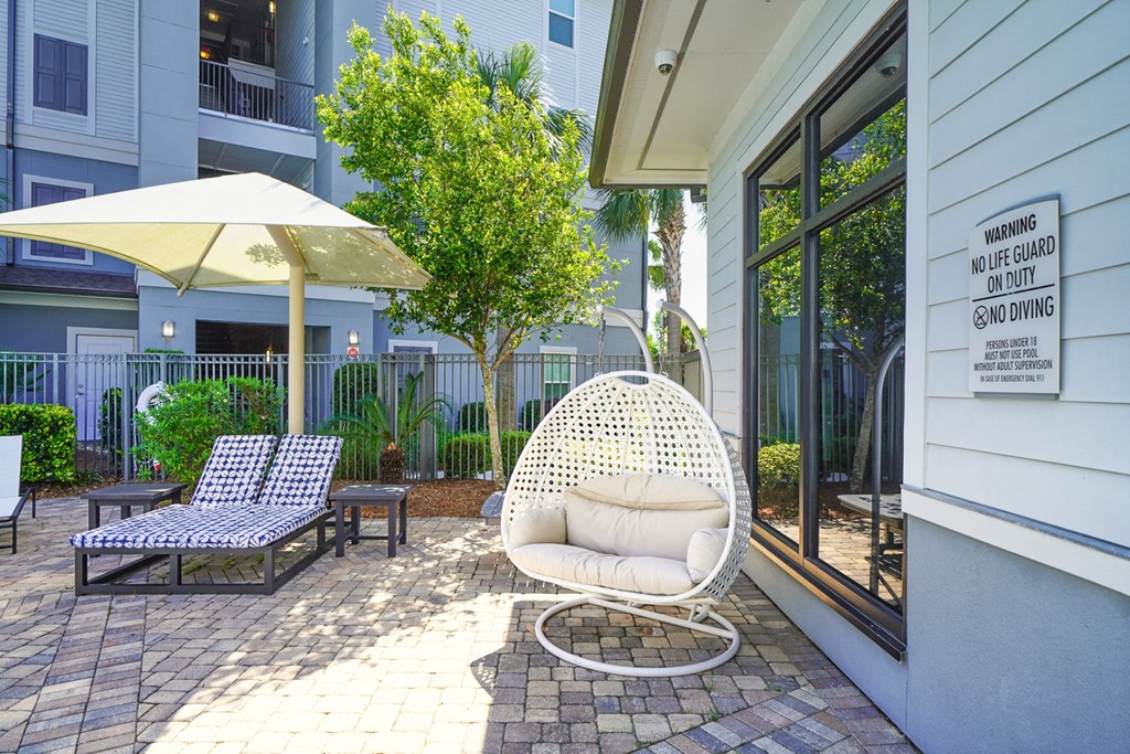 a white egg chair sitting outside of a building