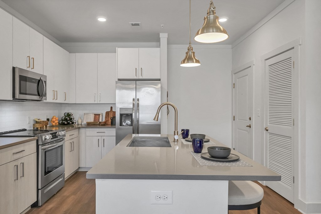 a kitchen with white cabinets and stainless steel appliances at The Indigo Apartments, Canton, 30114