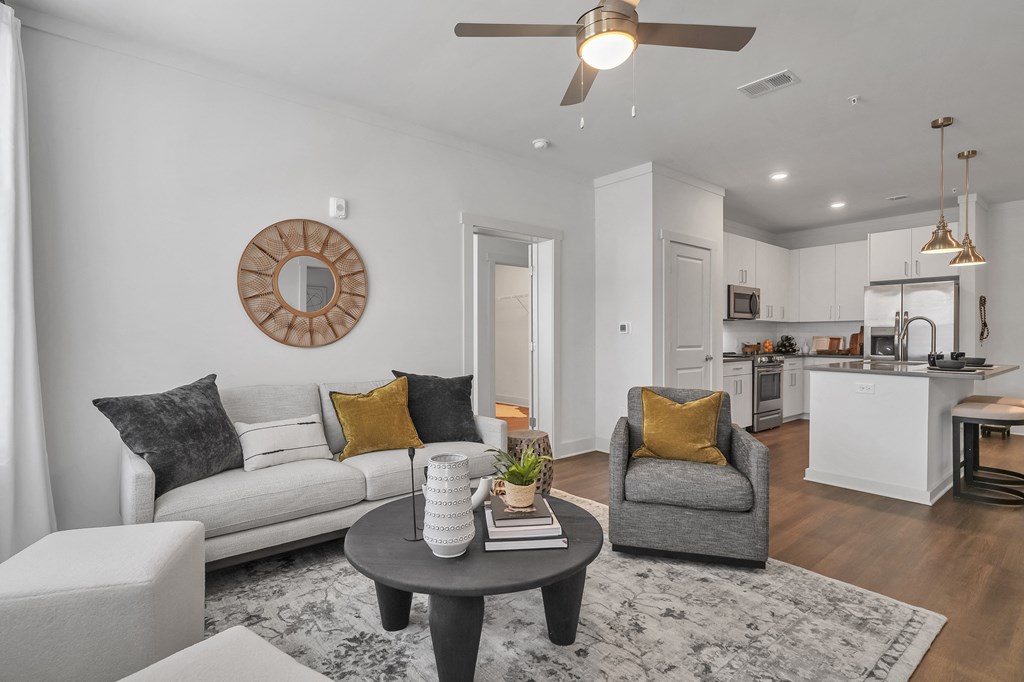 a living room with white walls and a ceiling fan at The Indigo Apartments, Canton, GA, 30114