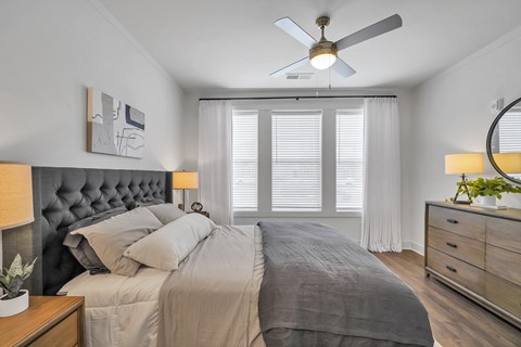 a bedroom with a large bed and a ceiling fan at The Indigo Apartments, Georgia