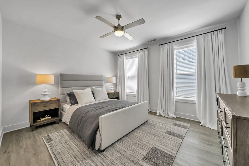 a bedroom with a bed and two windows  at The Landing on Summers Street, Georgia