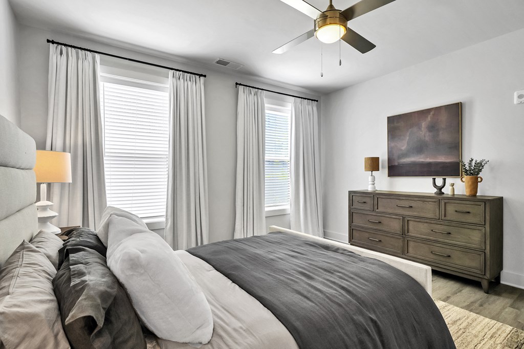 a bedroom with a large bed and two windows  at The Landing on Summers Street, Georgia, 30144